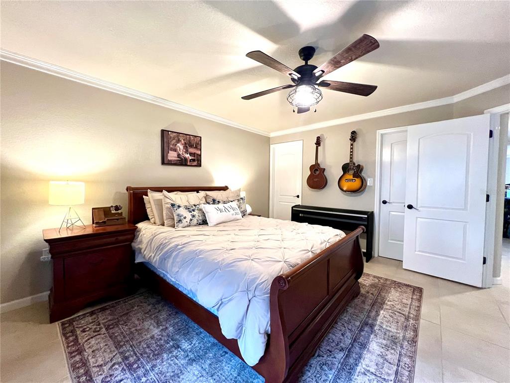 2101 Hammock Pine Boulevard, Unit 2101 Clearwater, FL 33761 - Photo 12 of 24 a bed room with a bed and a chandelier