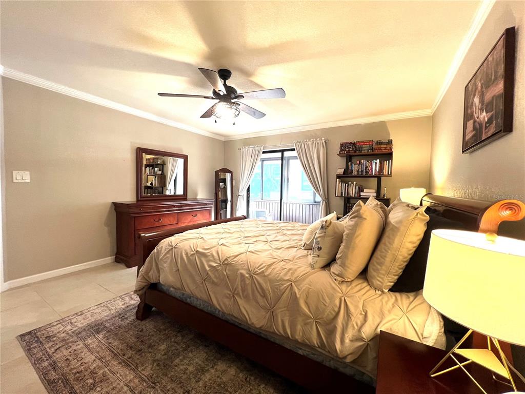 2101 Hammock Pine Boulevard, Unit 2101 Clearwater, FL 33761 - Photo 14 of 24 a bedroom with a bed dresser and a window