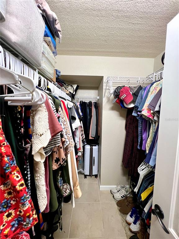 2101 Hammock Pine Boulevard, Unit 2101 Clearwater, FL 33761 - Photo 15 of 24 a view of walk in closet with clothes and shoes
