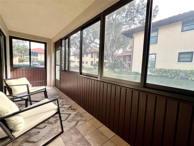 a view of a living room floor and a balcony with furniture