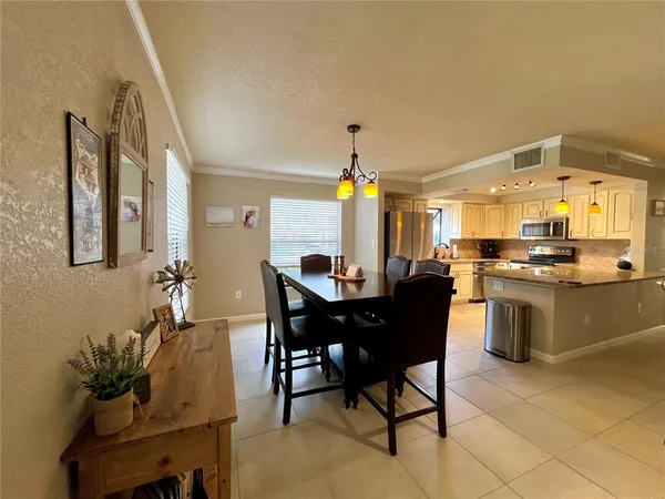 a kitchen with a table and chairs in it