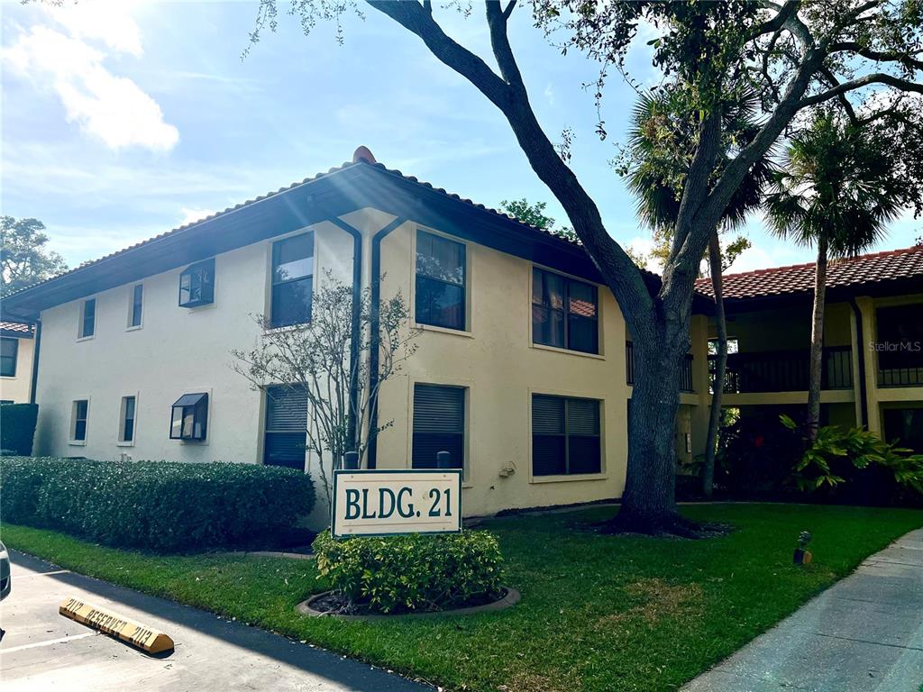 2101 Hammock Pine Boulevard, Unit 2101 Clearwater, FL 33761 - Photo 21 of 24 a front view of a house with a yard and garage