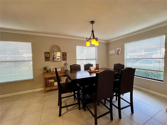 a view of a dining room with furniture and a window