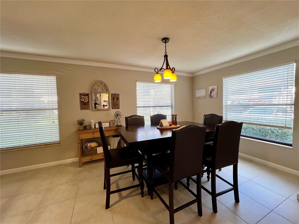 2101 Hammock Pine Boulevard, Unit 2101 Clearwater, FL 33761 - Photo 3 of 24 a view of a dining room with furniture and a window