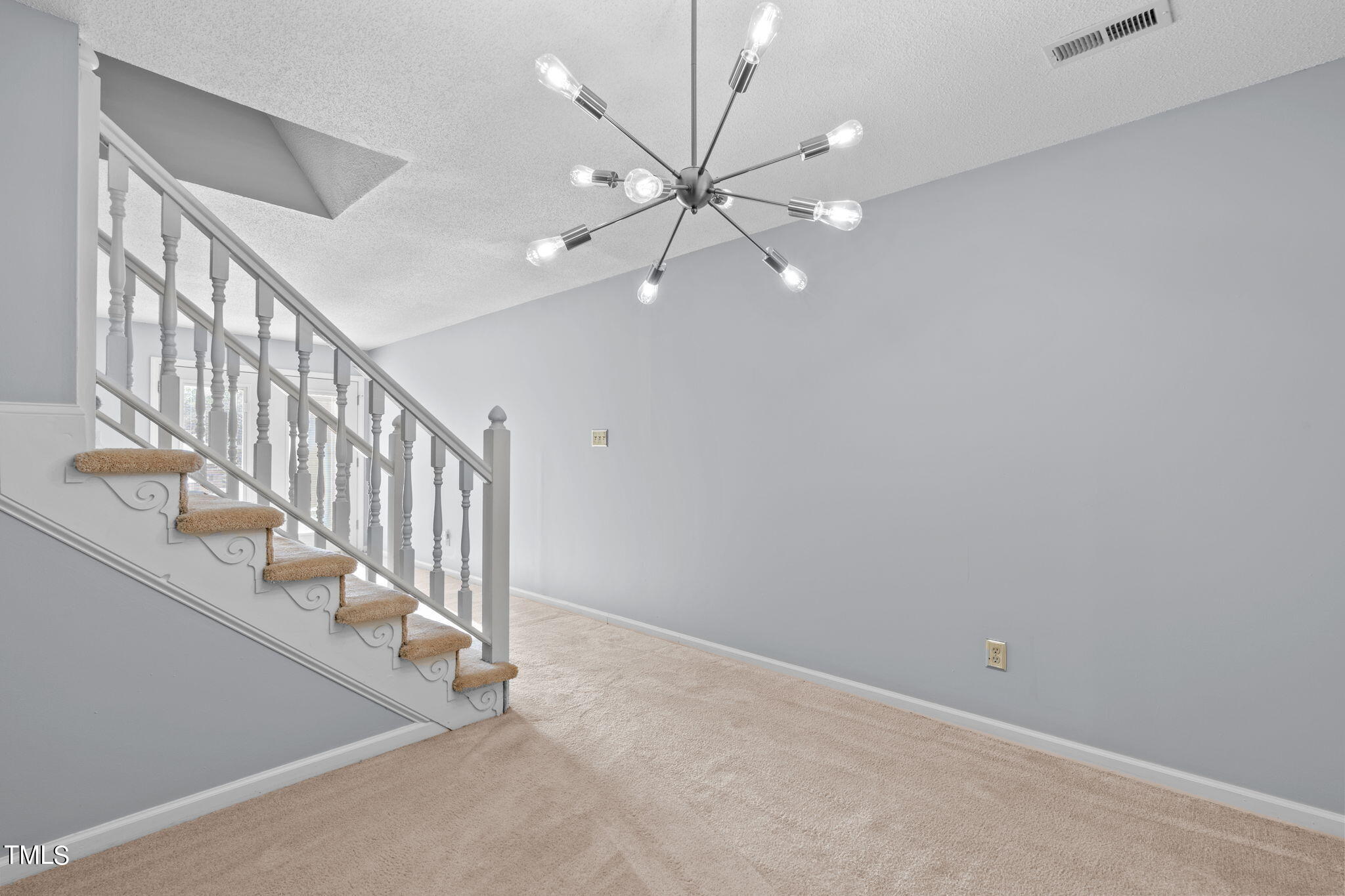 240 Clancy Circle Cary, NC 27511 - Photo 11 of 27 wooden floor in an empty room with a chandelier fan