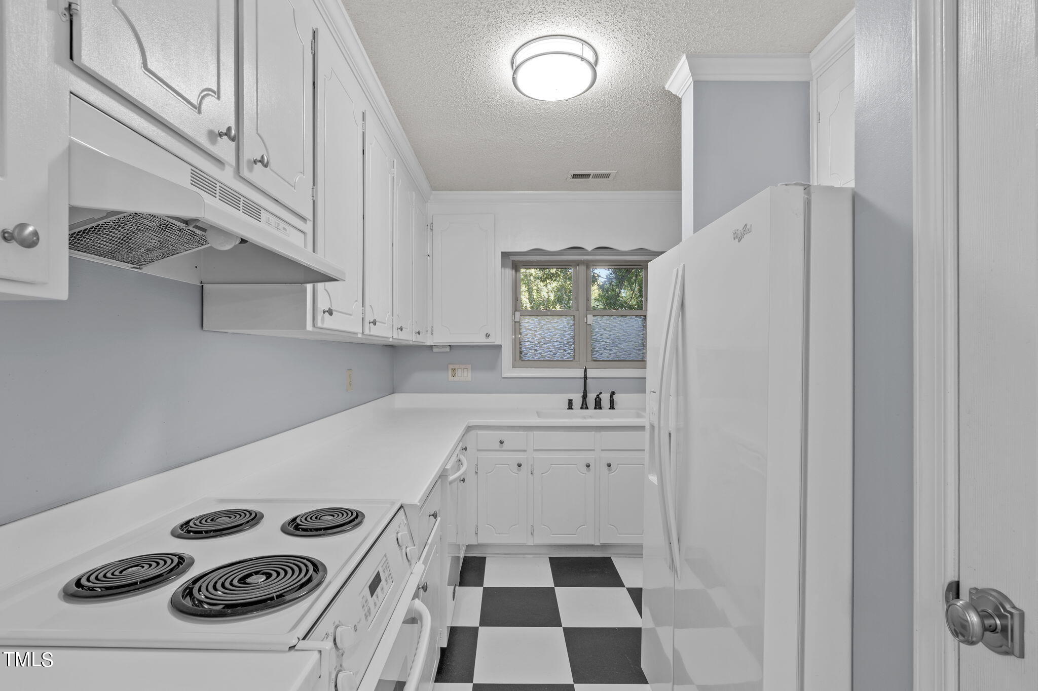 240 Clancy Circle Cary, NC 27511 - Photo 12 of 27 a kitchen with a stove and a refrigerator