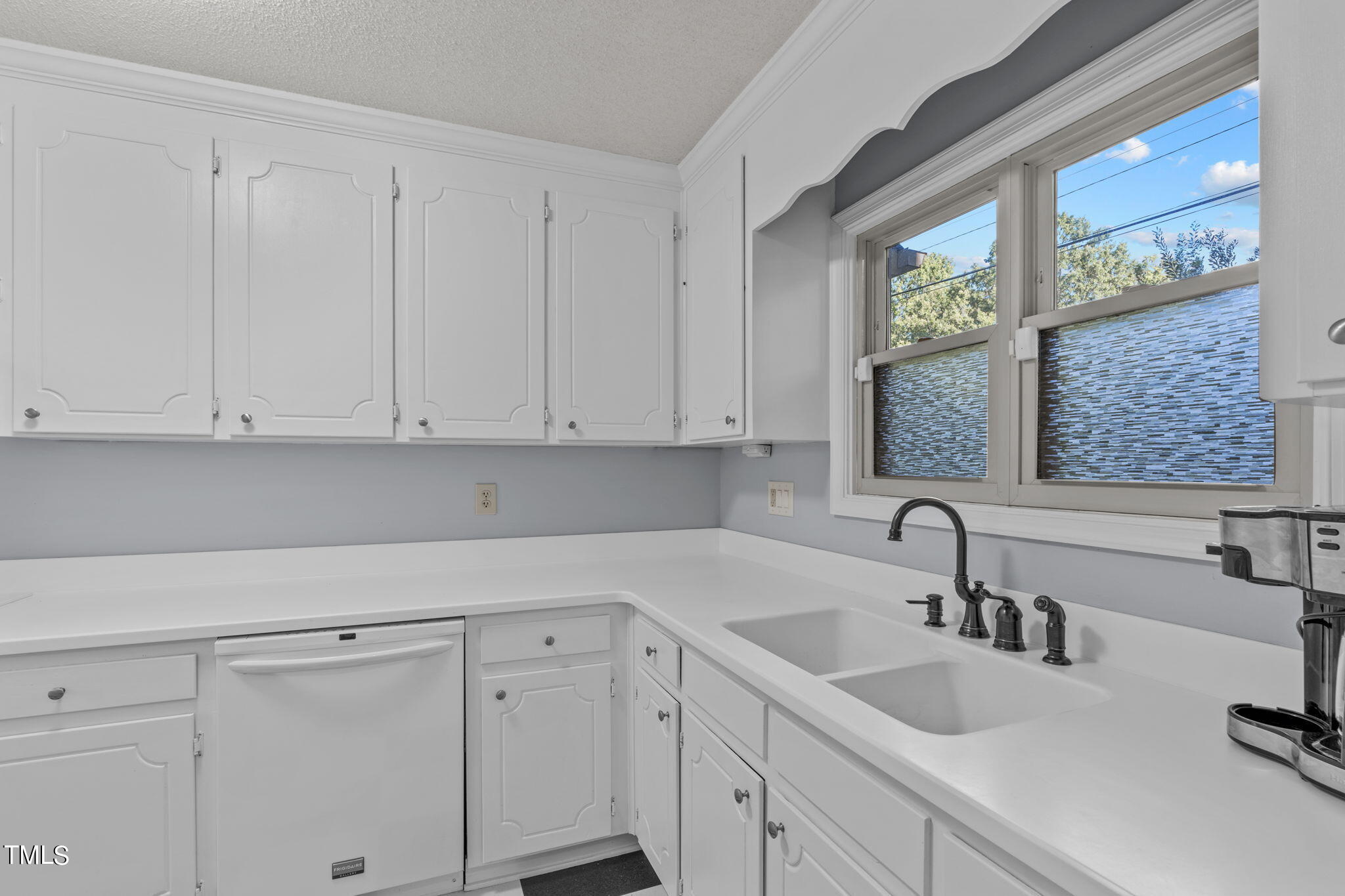 240 Clancy Circle Cary, NC 27511 - Photo 13 of 27 a kitchen with white cabinets and sink
