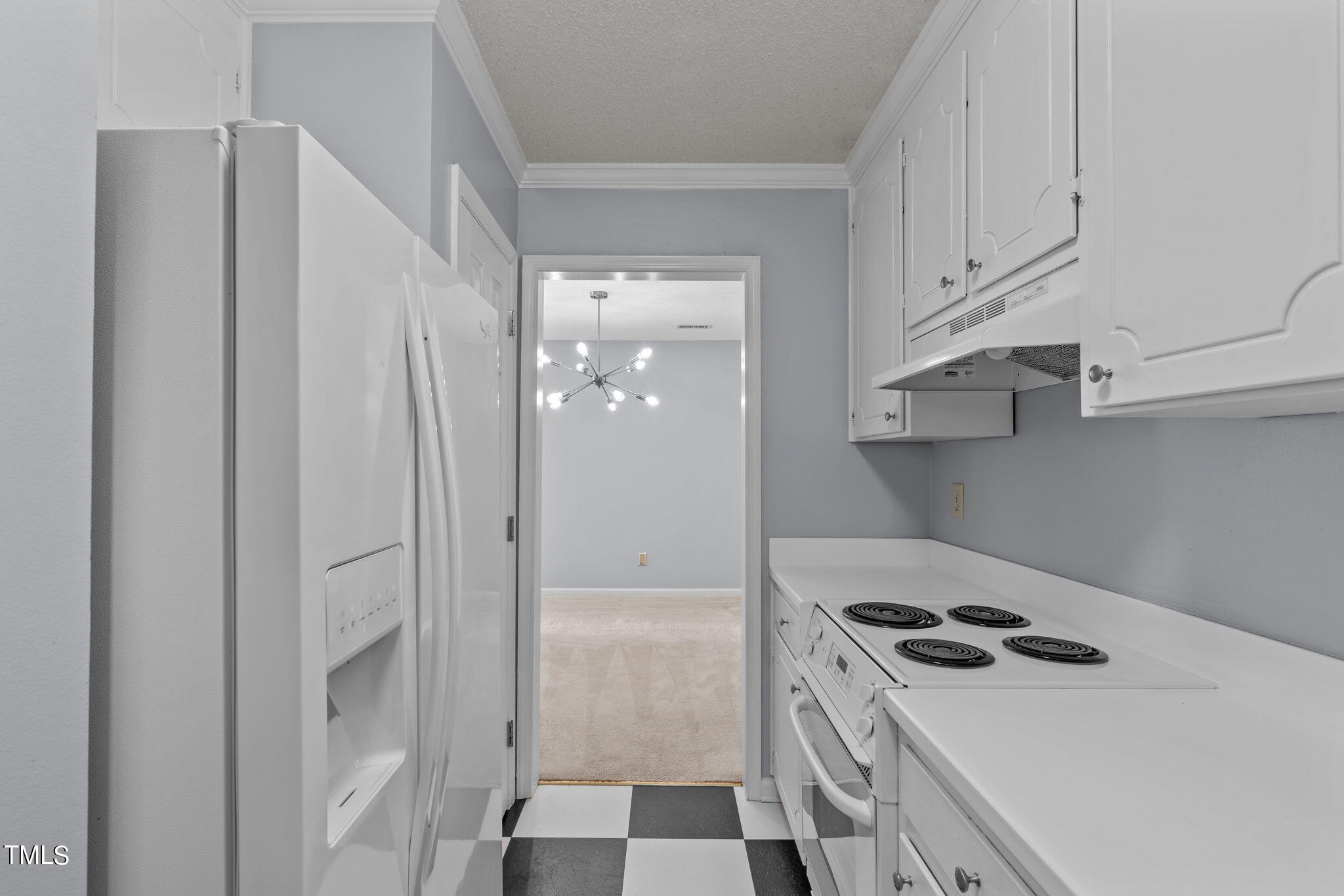 240 Clancy Circle Cary, NC 27511 - Photo 14 of 27 a kitchen with stainless steel appliances a stove a refrigerator and cabinets