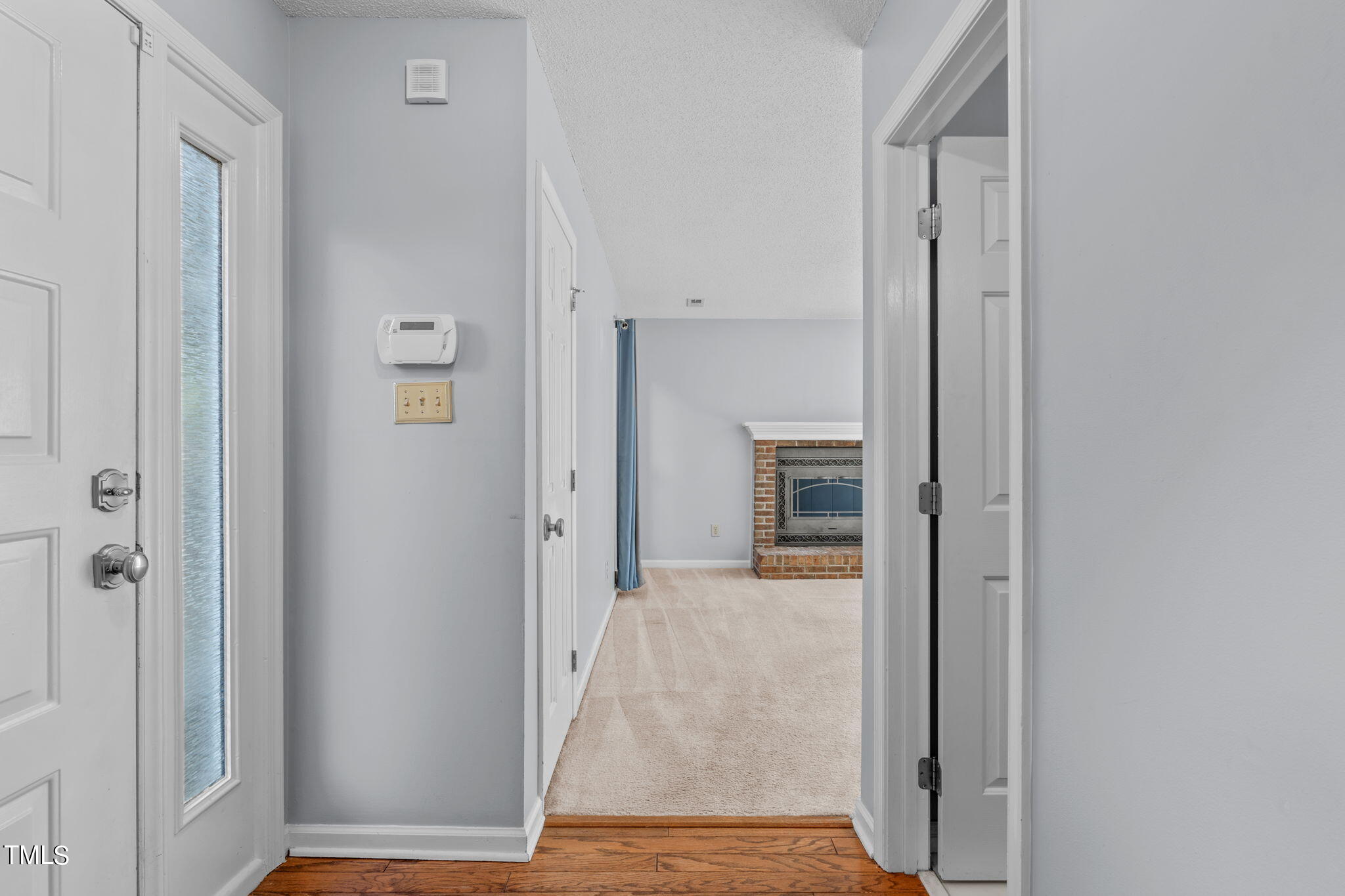 240 Clancy Circle Cary, NC 27511 - Photo 3 of 27 a view of a hallway with wooden floor and entryway