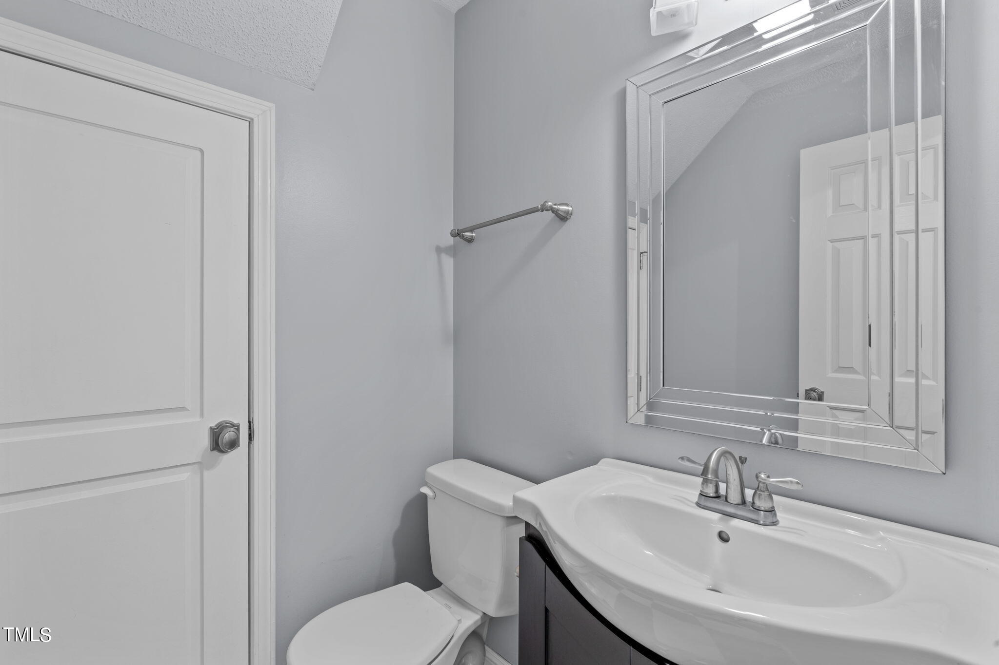240 Clancy Circle Cary, NC 27511 - Photo 4 of 27 a bathroom with a sink toilet and a mirror