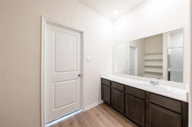 a bathroom with a double vanity sink and mirror