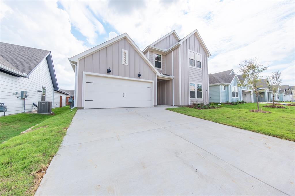 13156 Dawson Drive Providence Village, TX 76227 - Photo 2 of 31 a view of a white house with a big yard and large tree