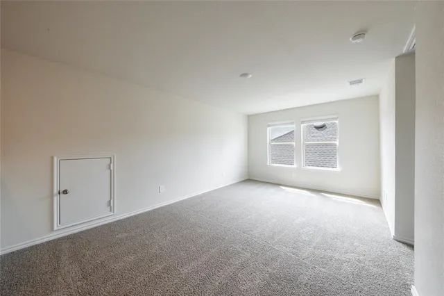 an empty room with a empty space and windows