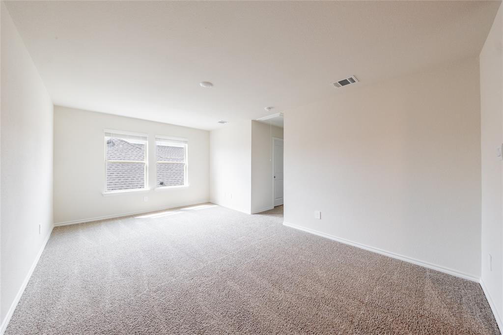 13156 Dawson Drive Providence Village, TX 76227 - Photo 25 of 31 a view of an empty room with a window