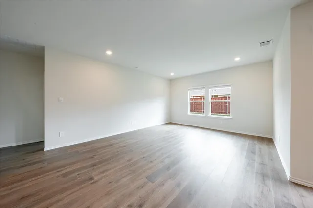 a view of a room wooden floor and window in a room