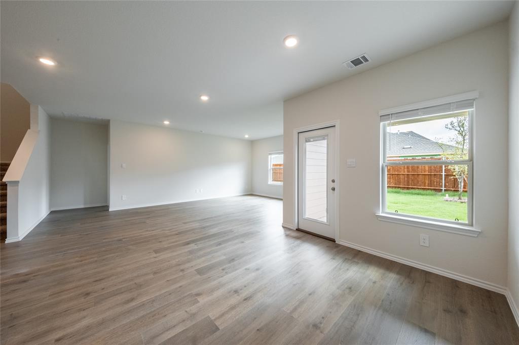 13156 Dawson Drive Providence Village, TX 76227 - Photo 10 of 31 an empty room with wooden floor and windows