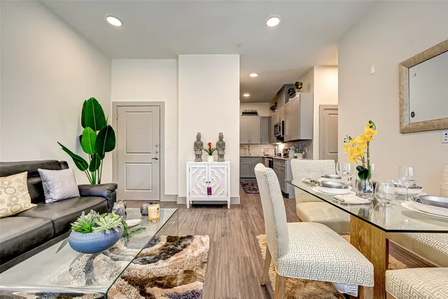 a living room with furniture a rug and a chandelier