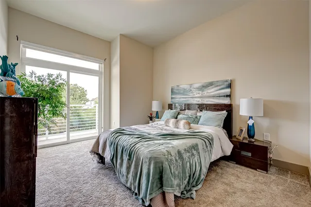 a bed sitting in a bedroom next to a window
