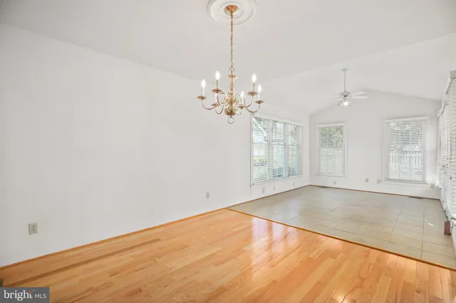 a view of a room with wooden floor and chandelier