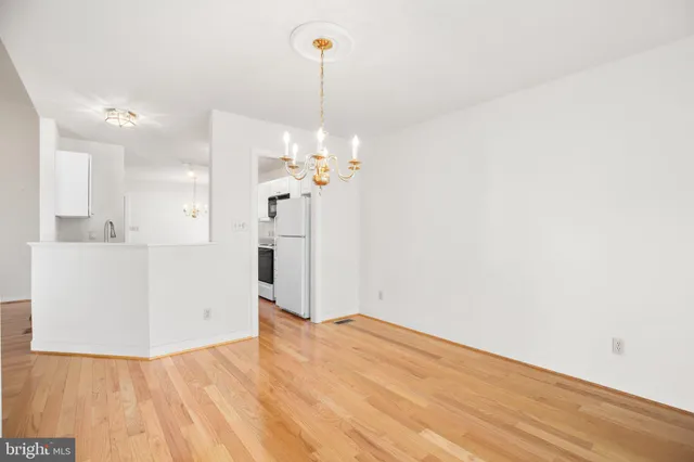 a view of a kitchen with wooden floor and a sink