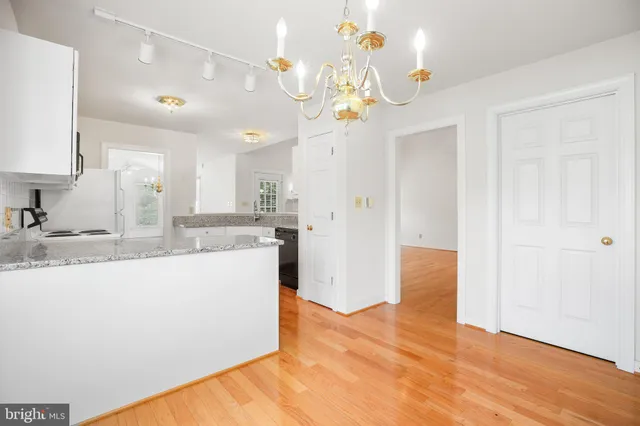 a view of a kitchen with a sink and refrigerator
