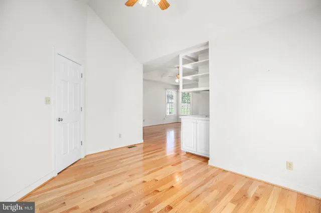 a view of empty room with wooden floor