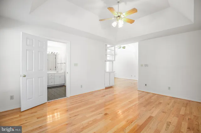a view of a big room with closet and a chandelier fan
