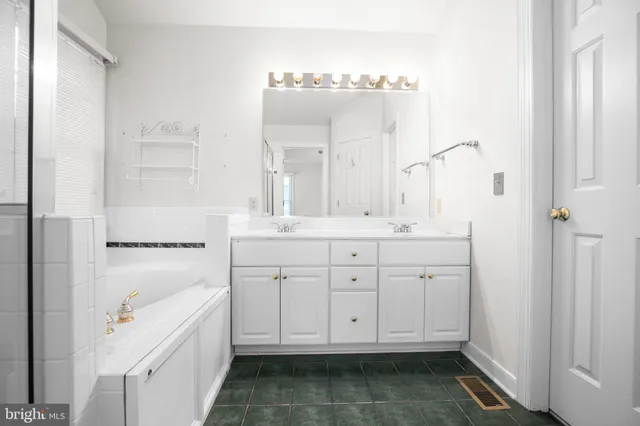 a bathroom with a double vanity sink and mirror