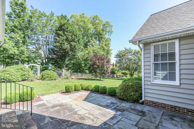 a view of a house with a yard and potted plants