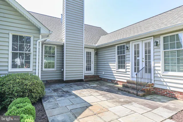 a view of a house with a small yard and a large window