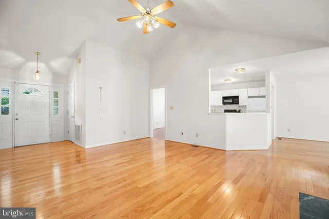 a view of a kitchen with a refrigerator and a stove top oven