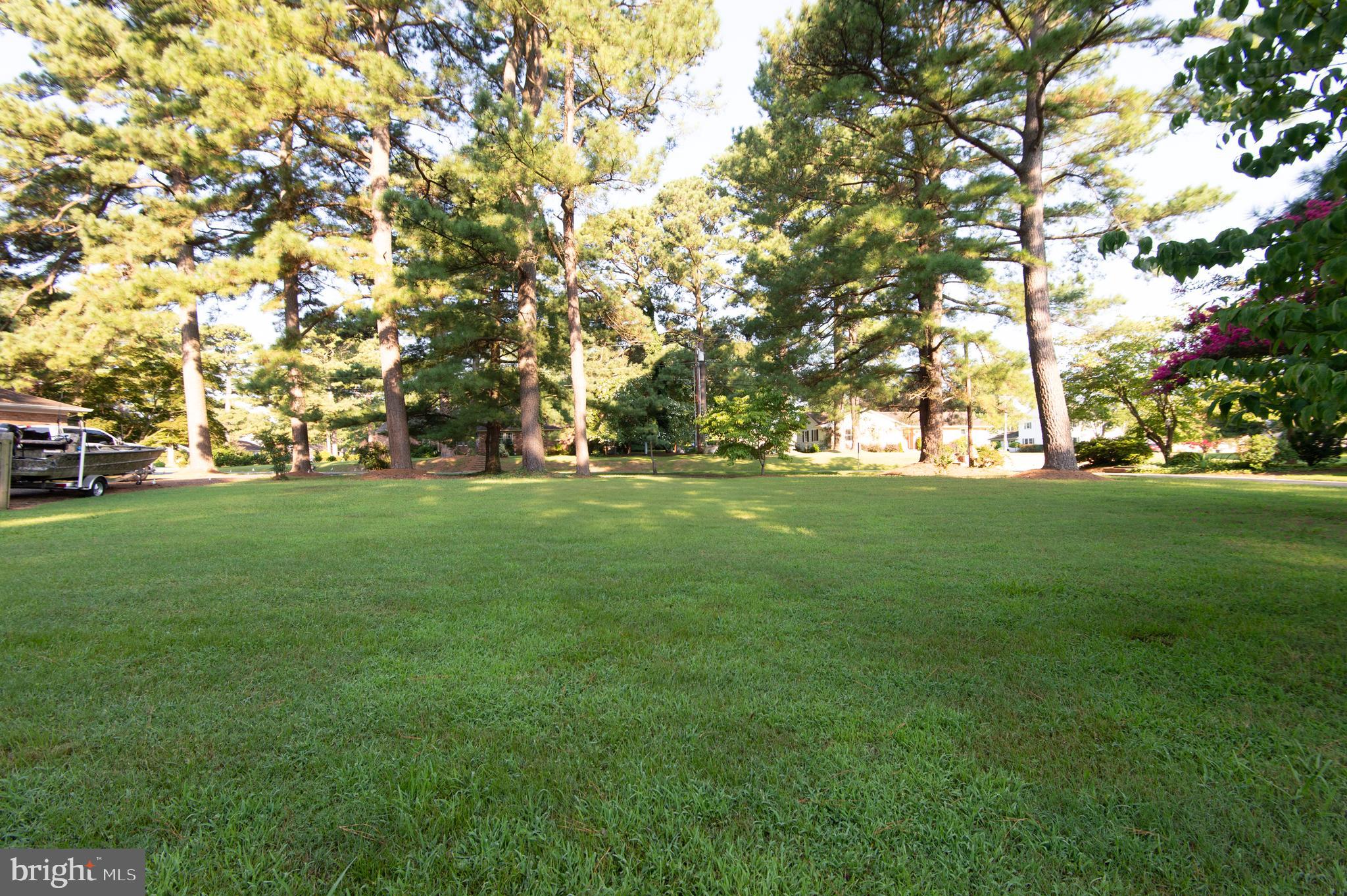 4 Algonquin Road Cambridge, MD 21613 - Photo 2 of 6 a view of grassy field with benches