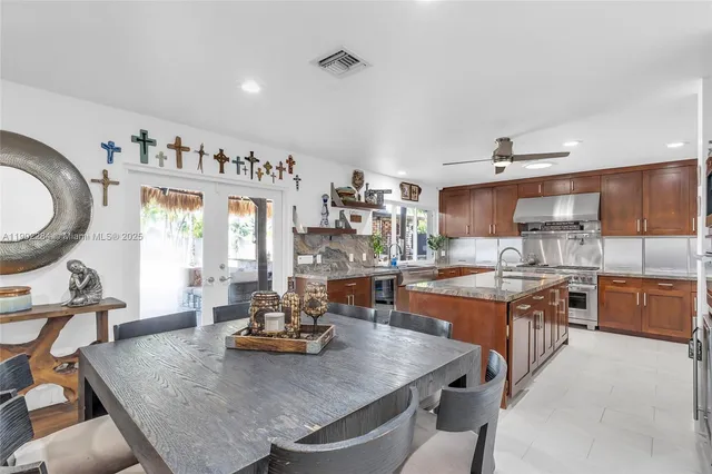 a kitchen with granite countertop a stove and a sink