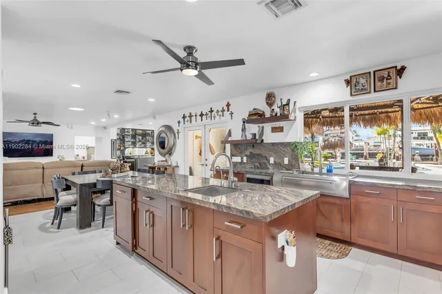 a kitchen with stainless steel appliances granite countertop sink stove and cabinets
