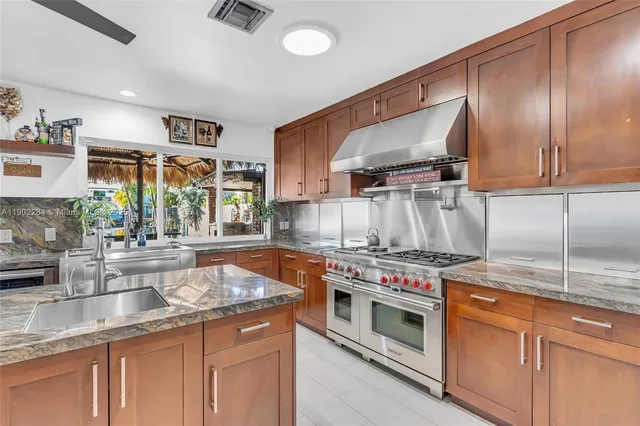 a bathroom with a granite countertop sink a toilet and bathtub