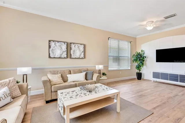 a living room with furniture and wooden floor