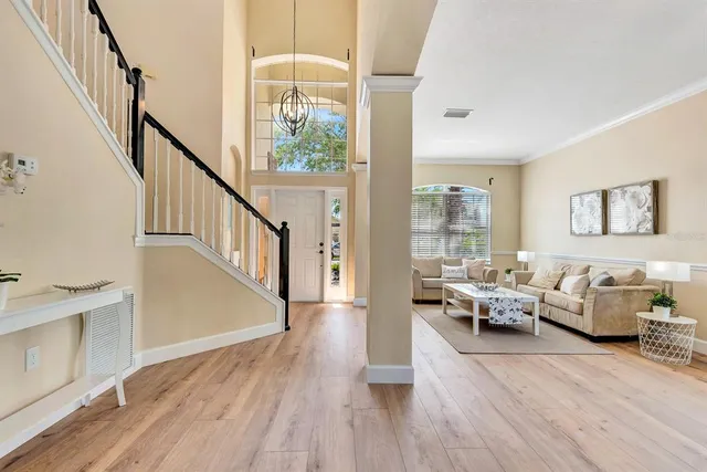 a dining hall with stainless steel appliances granite countertop a dining table chairs and view living room