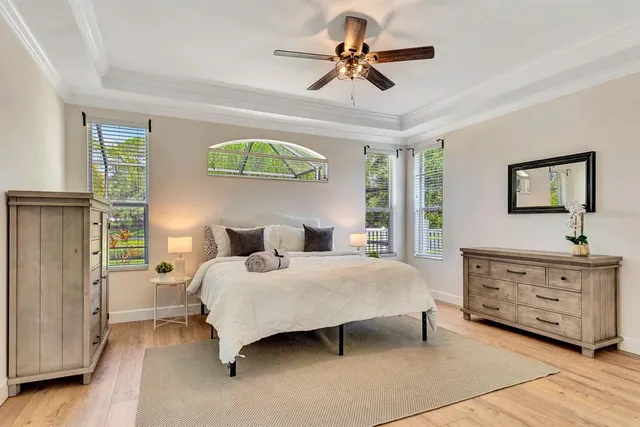 a bedroom with a bed and a chandelier