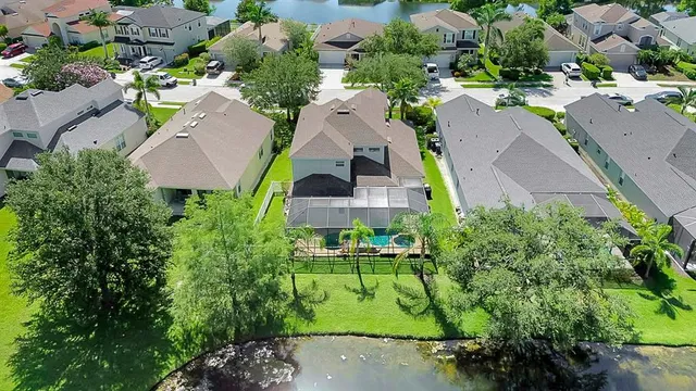 an aerial view of a house with a garden and swimming pool