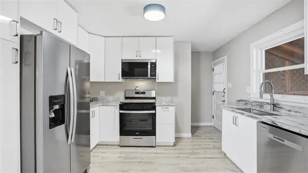 a kitchen with stainless steel appliances a refrigerator stove and sink