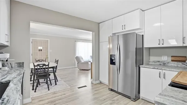 a kitchen with stainless steel appliances granite countertop a refrigerator and a stove top oven