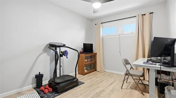 a view of a workspace with furniture and a flat screen tv