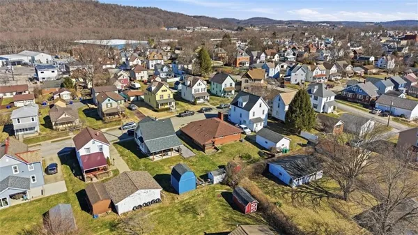 an aerial view of residential houses with city view