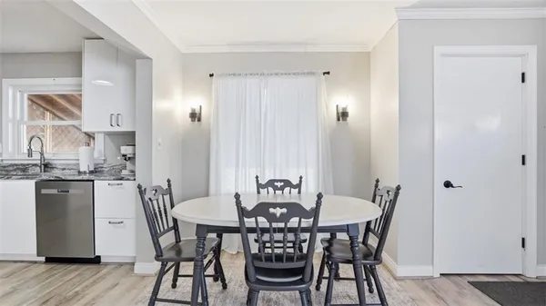 a view of a dining room with furniture and wooden floor