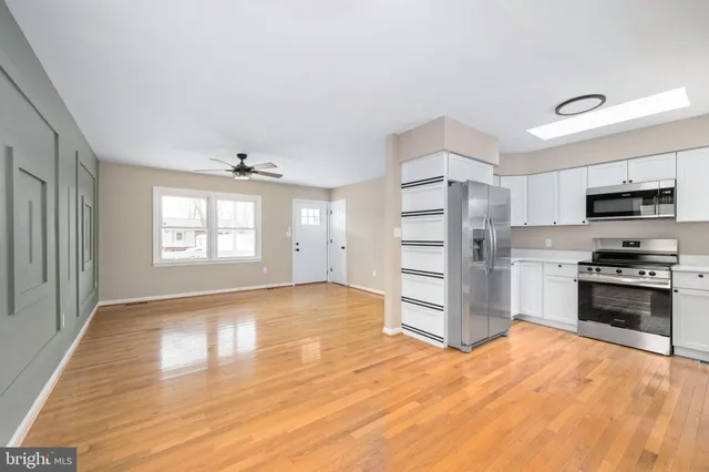 a view of a kitchen with a stove cabinets and wooden floor