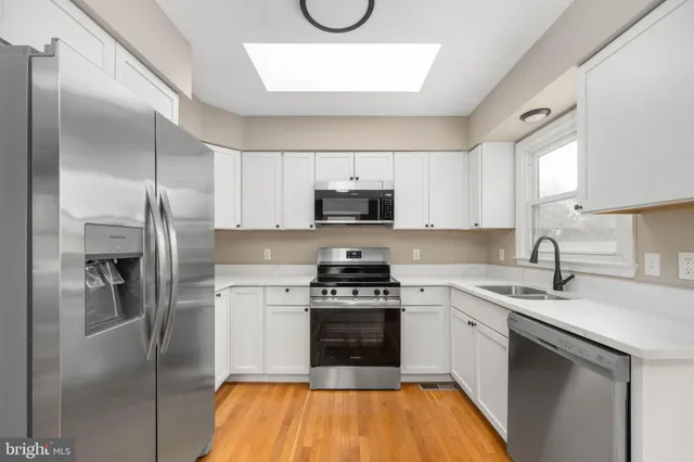 a kitchen with a sink stove and refrigerator