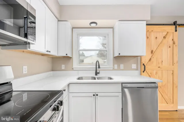 a kitchen with a sink and a refrigerator