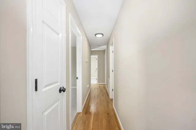 a view of a hallway with a white door