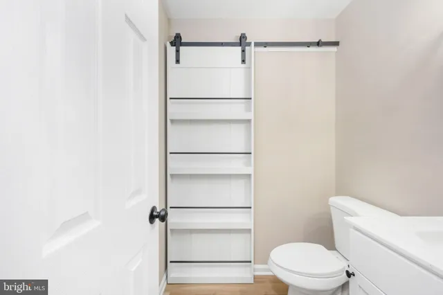 a white toilet sitting next to a shower
