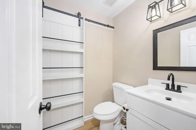 a bathroom with a toilet sink and a mirror